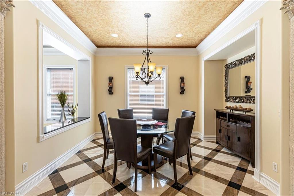 2135 Par Drive Naples, FL 34120 - Photo 11 of 49 a dining room with furniture a chandelier and wooden floor