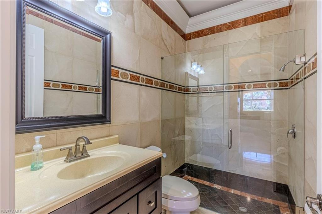 2135 Par Drive Naples, FL 34120 - Photo 14 of 49 a bathroom with a sink a toilet and shower