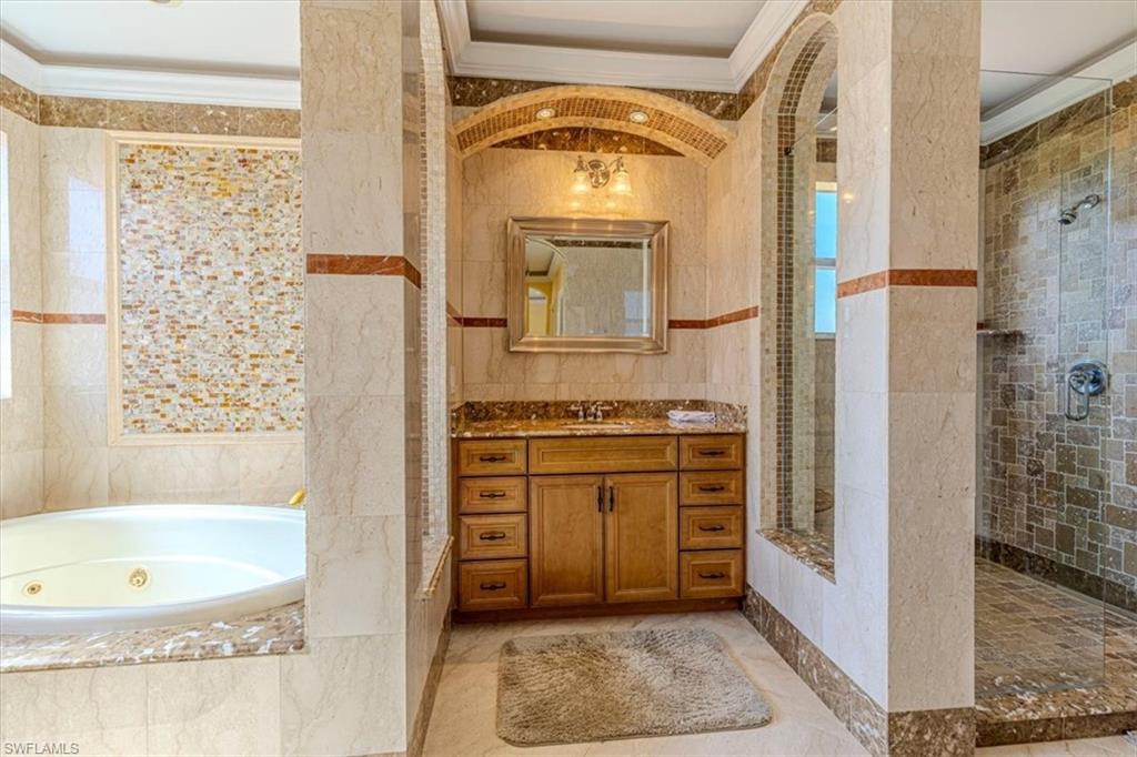 2135 Par Drive Naples, FL 34120 - Photo 22 of 49 a bathroom with a tub sink and a mirror