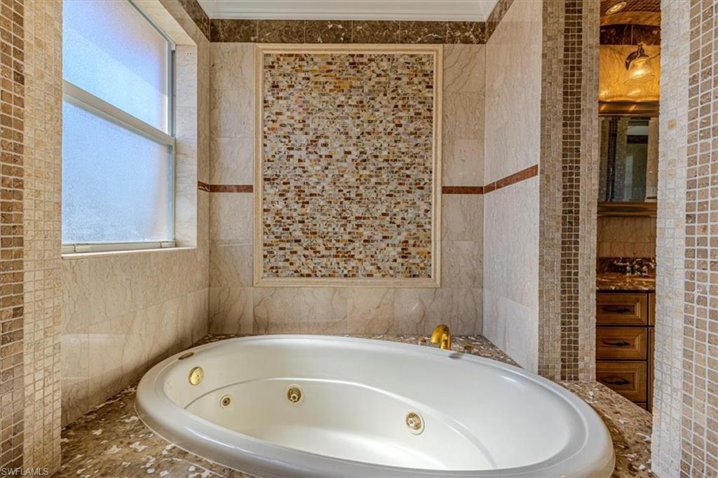 2135 Par Drive Naples, FL 34120 - Photo 24 of 49 a bathroom with a bathtub and shower