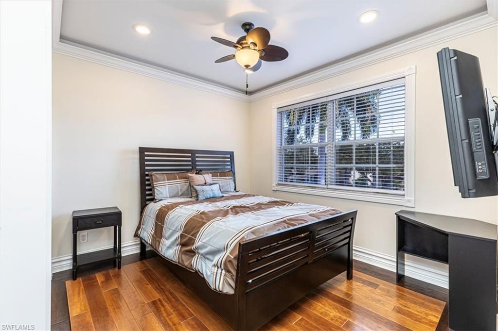 2135 Par Drive Naples, FL 34120 - Photo 32 of 49 a bedroom with a bed and a chandelier