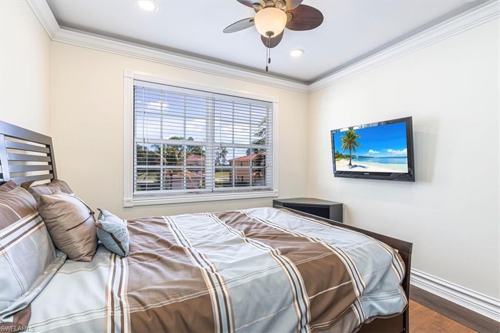 2135 Par Drive Naples, FL 34120 - Photo 34 of 49 a bedroom with a large bed and a window