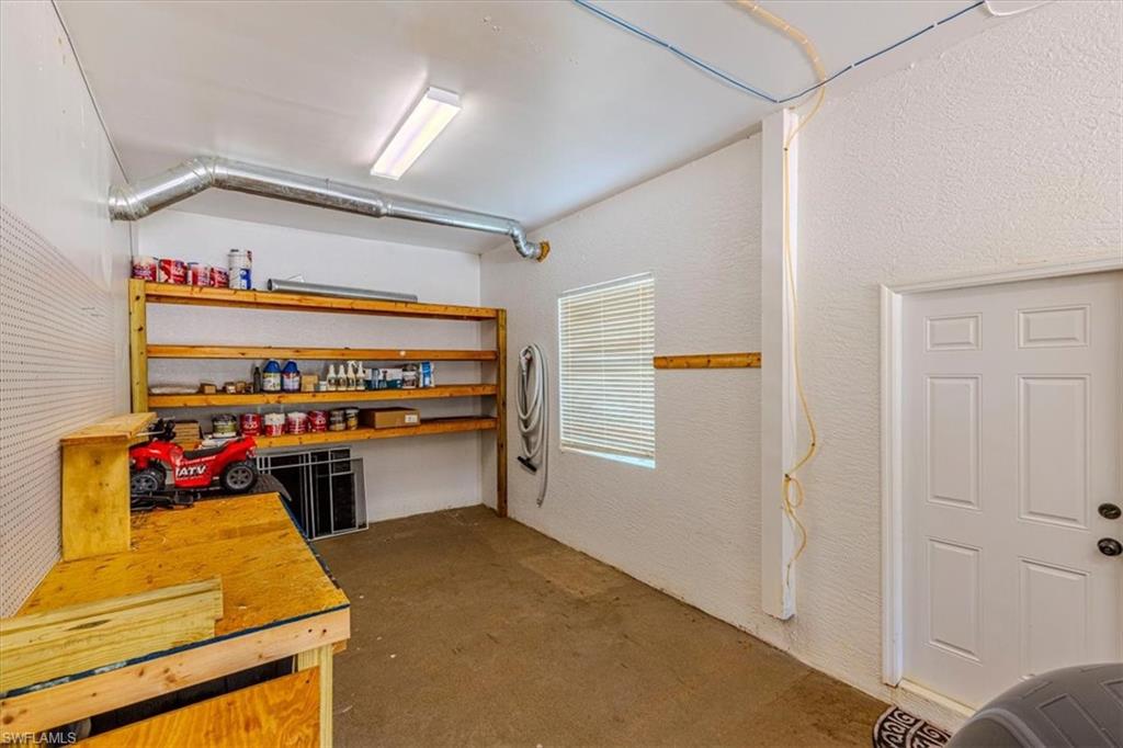 2135 Par Drive Naples, FL 34120 - Photo 44 of 49 a kitchen with stainless steel appliances granite countertop a stove and a refrigerator