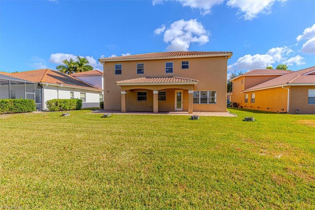 2135 Par Drive Naples, FL 34120 - Photo 46 of 49 a front view of a house with garden
