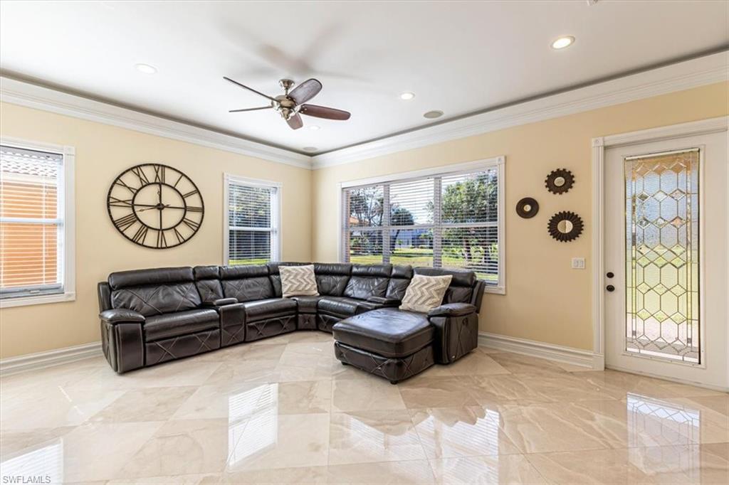 2135 Par Drive Naples, FL 34120 - Photo 10 of 49 a living room with furniture a clock and a large window