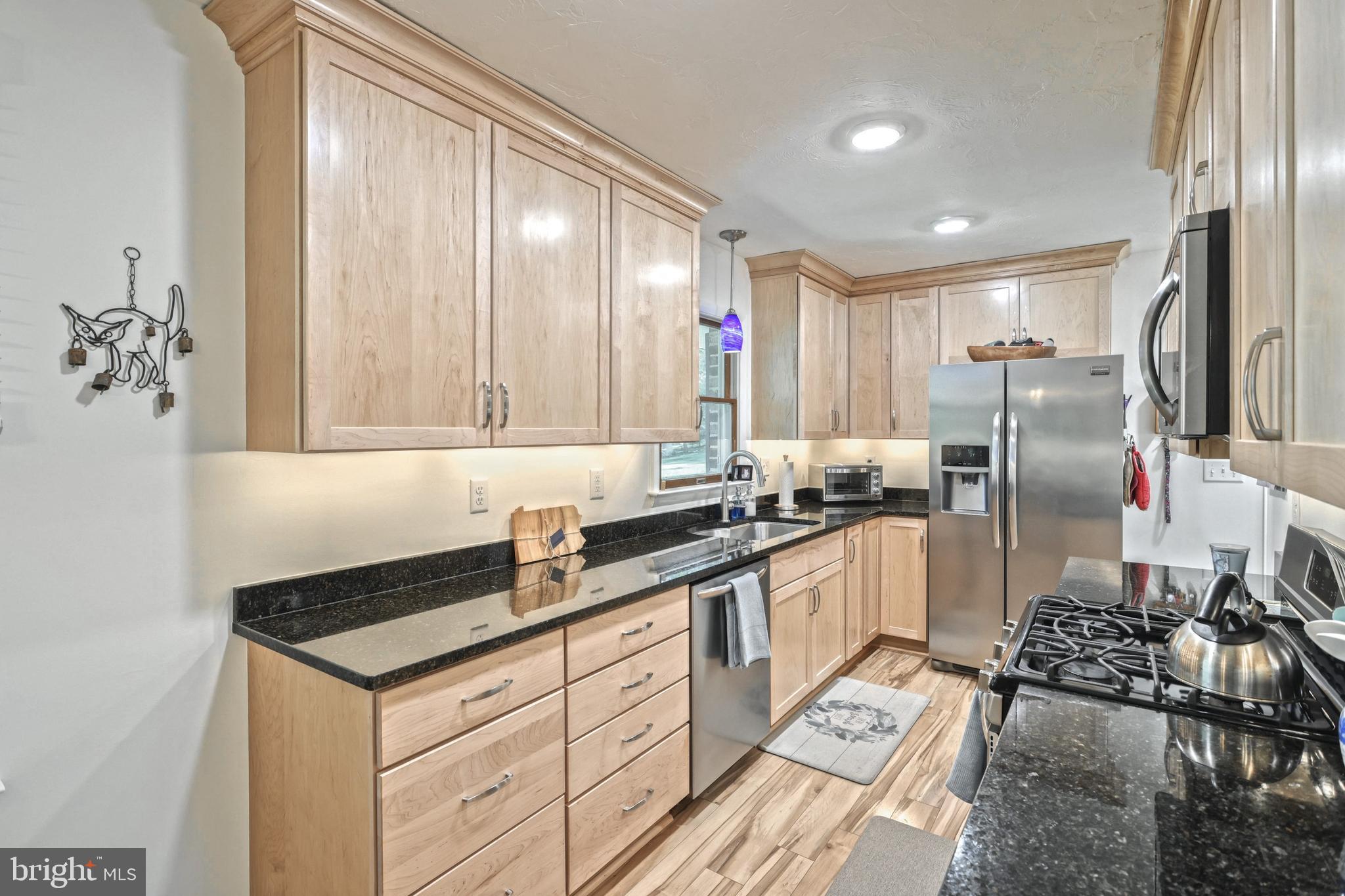 5071 Rislyn Court Spring Grove, PA 17362 - Photo 9 of 29 a kitchen with stainless steel appliances granite countertop a sink stove and refrigerator