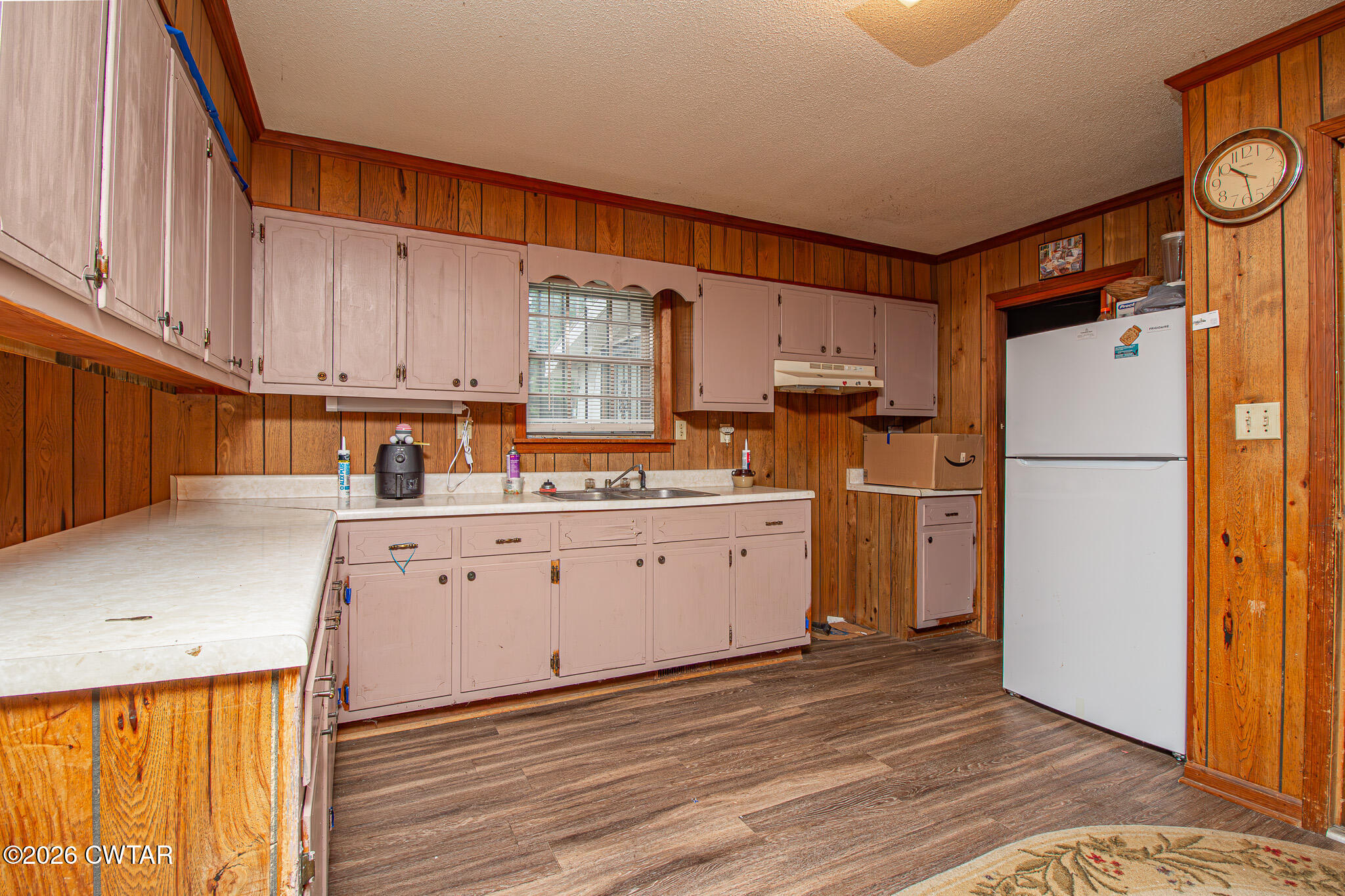 11 North Main Street Stanton, TN 38069 - Photo 4 of 18 a kitchen with a refrigerator a stove a microwave and cabinets