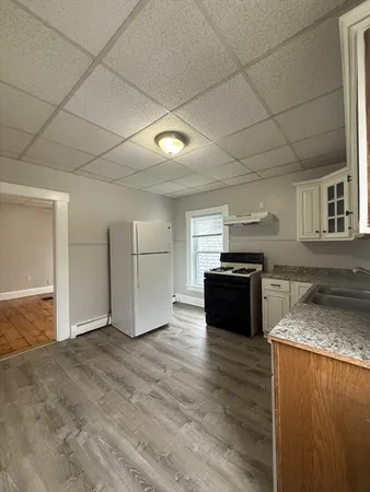 a kitchen with granite countertop a stove and a refrigerator