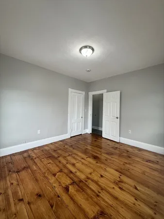 a view of an empty room and wooden floor