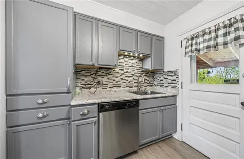 a kitchen with a sink and cabinets