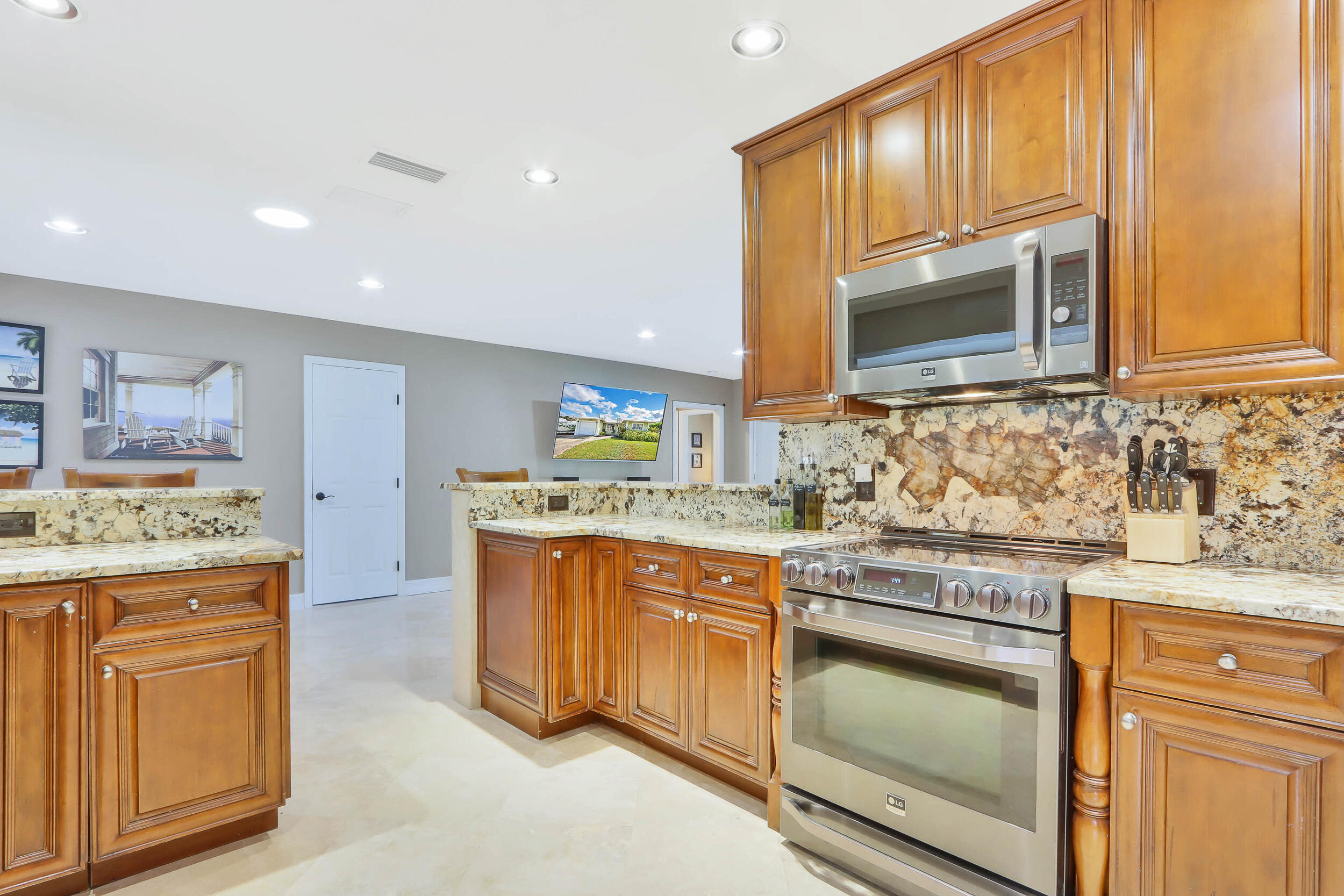 5512 Southeast Nassau Terrace Stuart, FL 34997 - Photo 11 of 24 a kitchen with stainless steel appliances granite countertop a stove and a sink