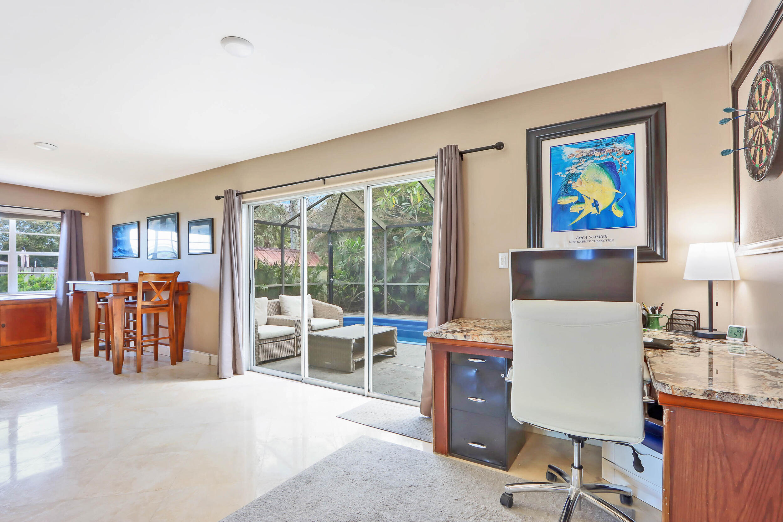 5512 Southeast Nassau Terrace Stuart, FL 34997 - Photo 12 of 24 a work room with furniture and a floor to ceiling window
