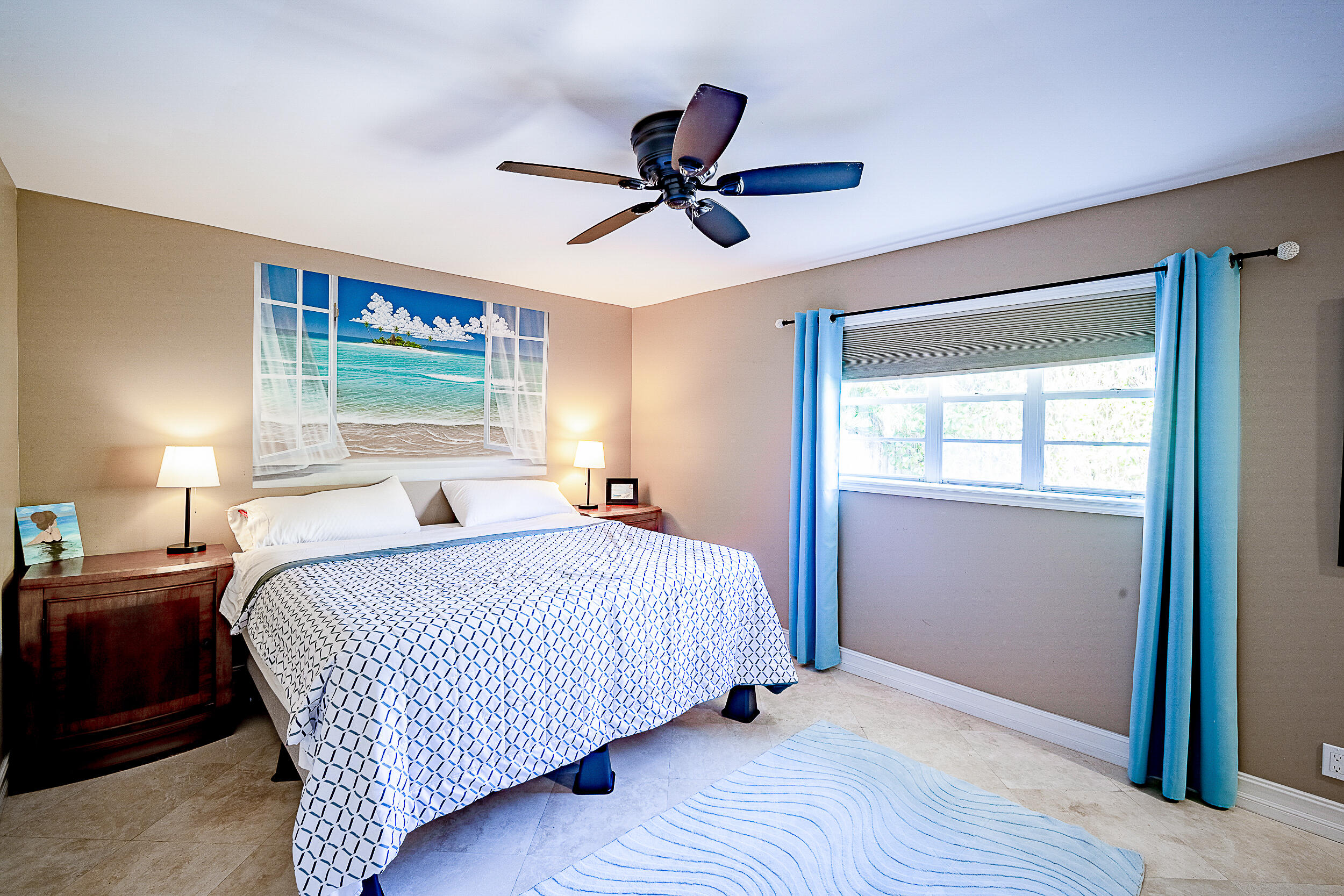 5512 Southeast Nassau Terrace Stuart, FL 34997 - Photo 13 of 24 a bedroom with a bed and window