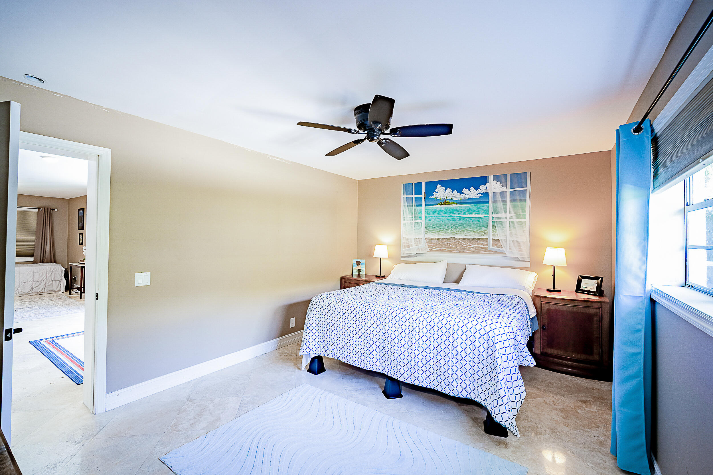 5512 Southeast Nassau Terrace Stuart, FL 34997 - Photo 14 of 24 a bedroom with a bed and a chandelier