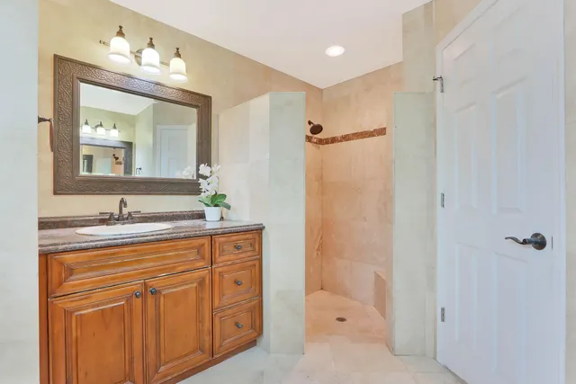 a bathroom with a granite countertop sink mirror and double