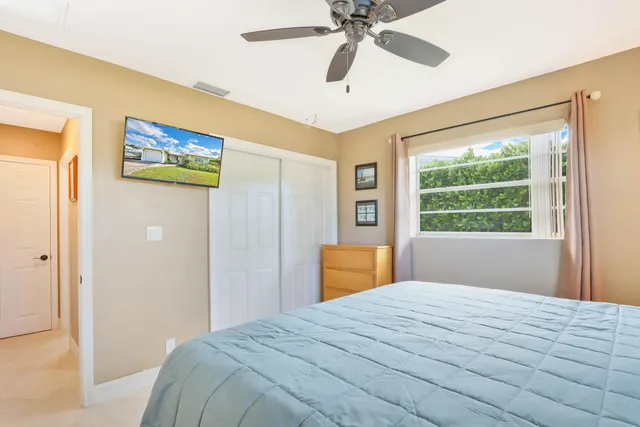 a bedroom with a large bed and a window