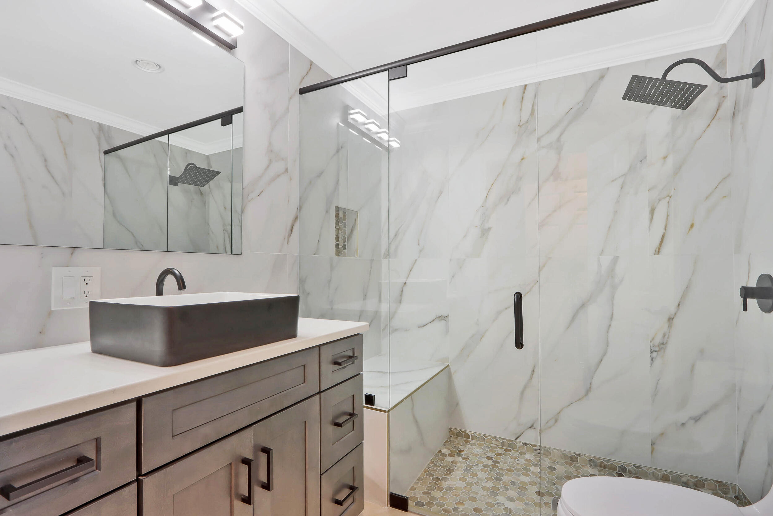 5512 Southeast Nassau Terrace Stuart, FL 34997 - Photo 20 of 24 a bathroom with a sink a toilet and shower