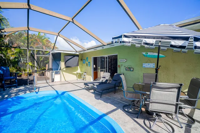 a view of a patio with table and chairs potted plants with wooden floor