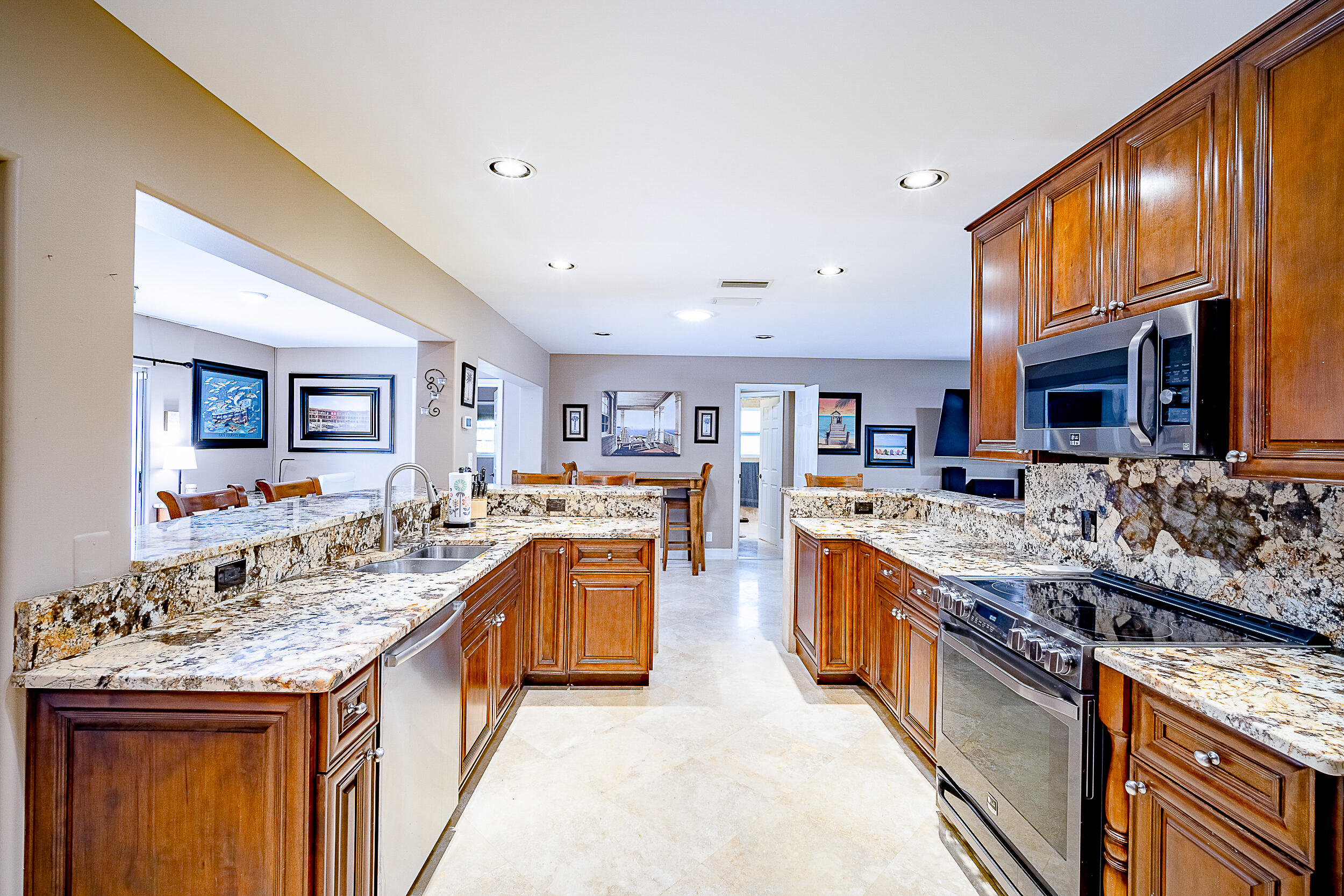 5512 Southeast Nassau Terrace Stuart, FL 34997 - Photo 9 of 24 a kitchen with stainless steel appliances granite countertop a stove and cabinets