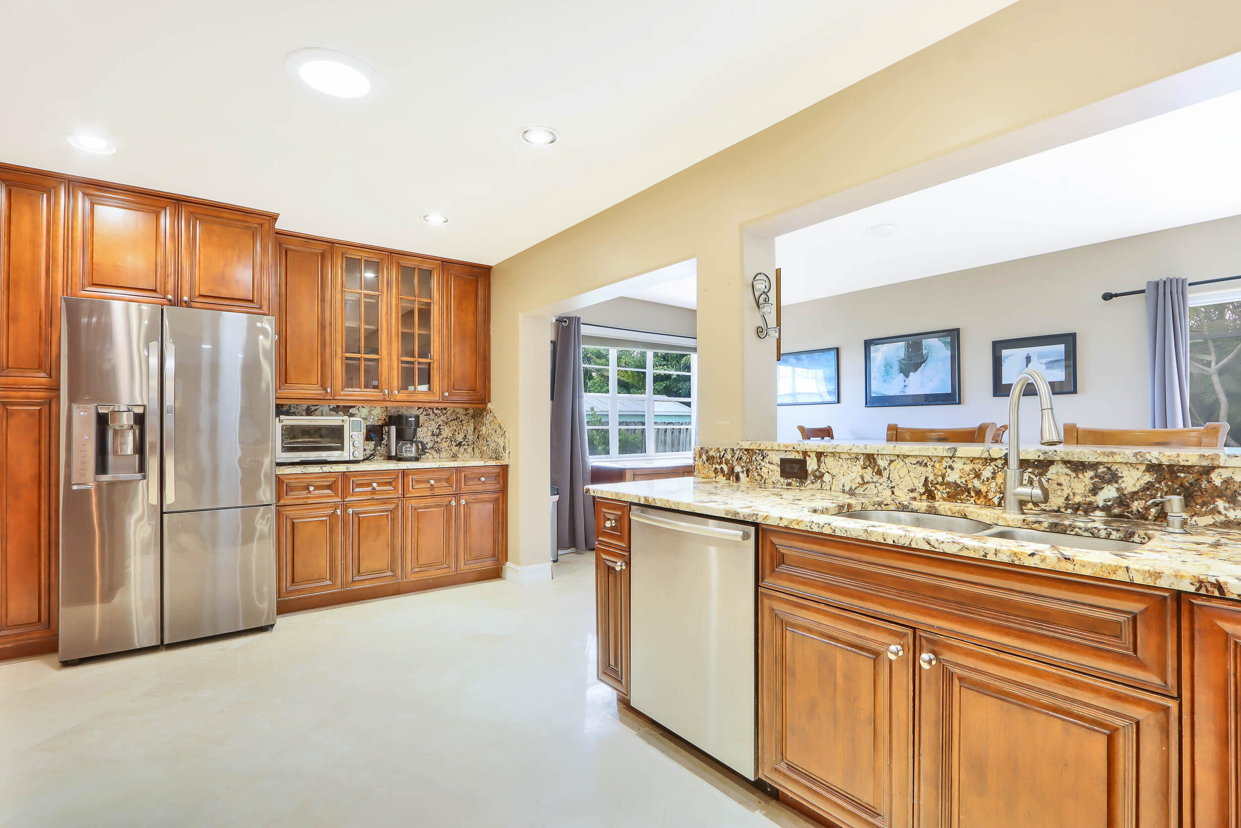 5512 Southeast Nassau Terrace Stuart, FL 34997 - Photo 10 of 24 a kitchen with stainless steel appliances granite countertop a refrigerator and cabinets