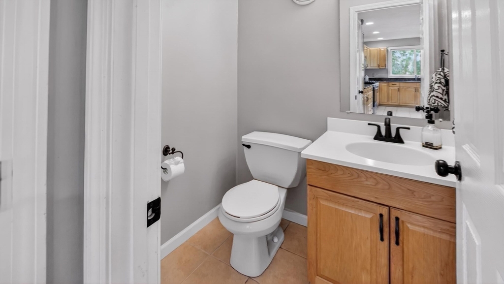 5 Governors Way, Unit B Milford, MA 01757 - Photo 22 of 42 a bathroom with a toilet sink and mirror