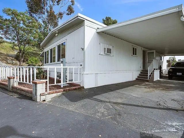 a view of a white house with large windows