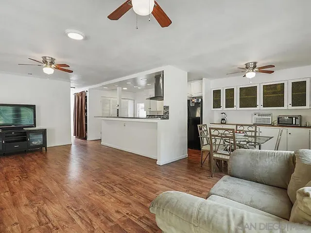 a living room with furniture and kitchen view