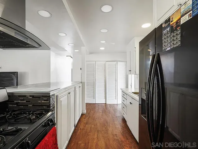 a kitchen with stainless steel appliances a refrigerator a stove a sink and a stove