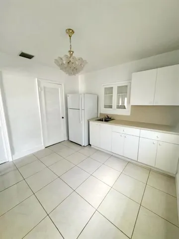 a kitchen with granite countertop a white cabinet and a granite counter tops