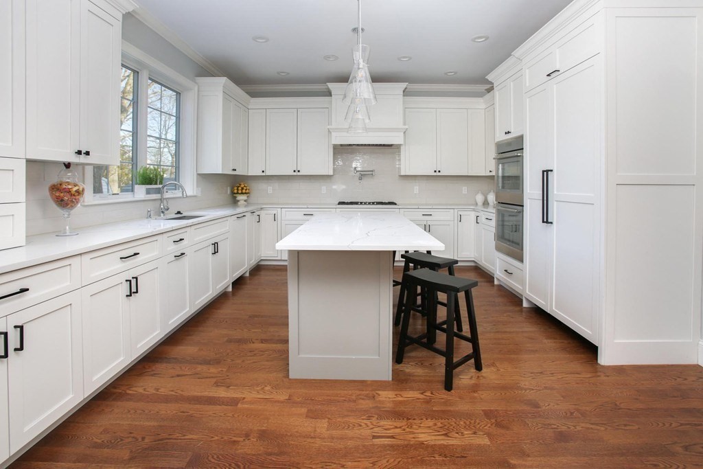 35 Hanson Road, Unit 35 Newton, MA 02459 - Photo 2 of 15 a kitchen with kitchen island granite countertop wooden floors and white appliances