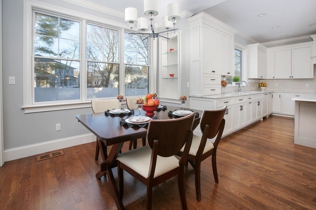 35 Hanson Road, Unit 35 Newton, MA 02459 - Photo 3 of 15 a dining room with furniture a chandelier and wooden floor