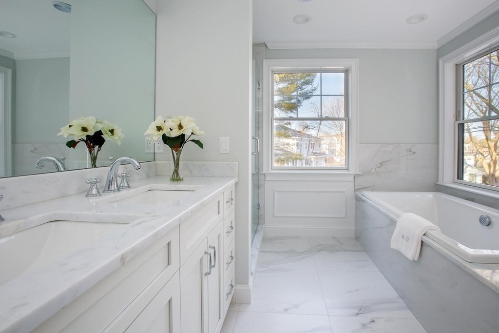 35 Hanson Road, Unit 35 Newton, MA 02459 - Photo 8 of 15 a bathroom with a granite countertop bathtub a sink and a window