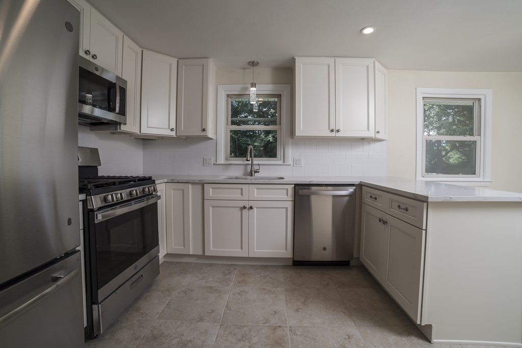 611 Allen Street Springfield, MA 01118 - Photo 19 of 37 a kitchen with white cabinets and white appliances