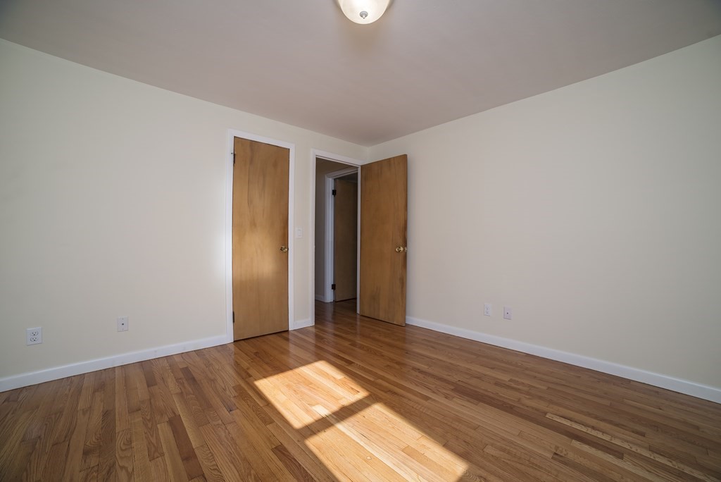 611 Allen Street Springfield, MA 01118 - Photo 30 of 37 an empty room with wooden floor and windows