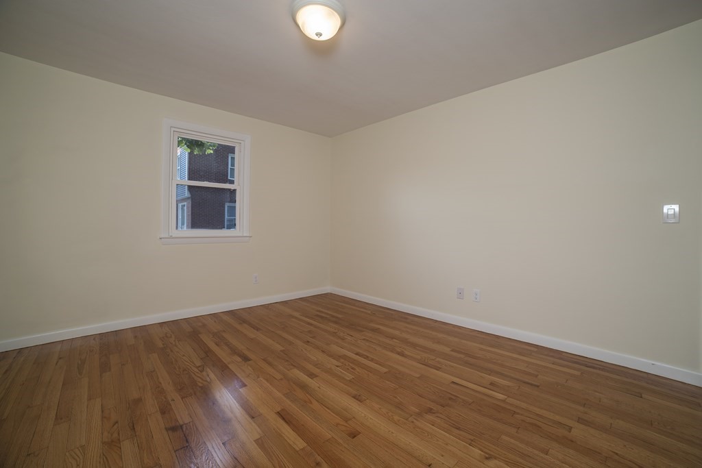 611 Allen Street Springfield, MA 01118 - Photo 33 of 37 a view of an empty room with wooden floor and a window