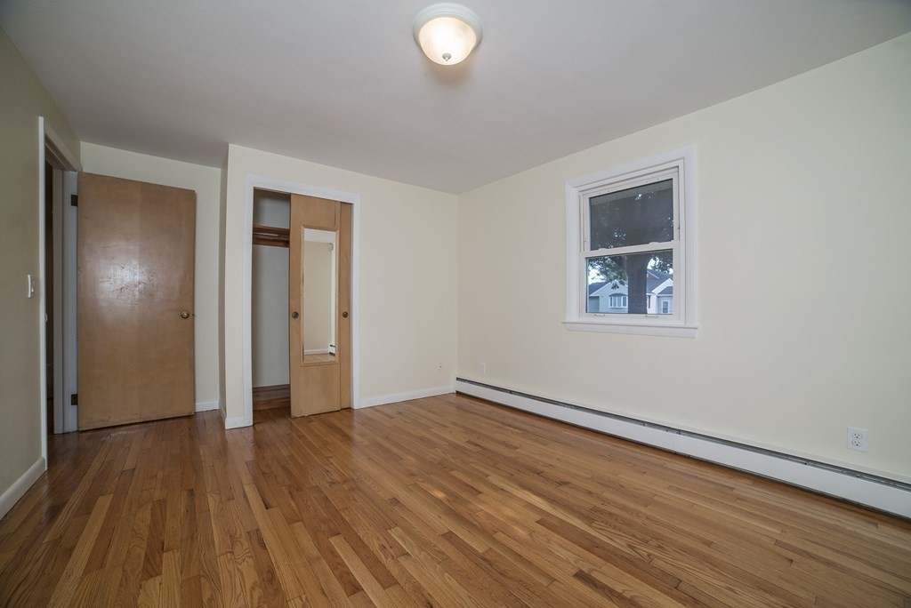 611 Allen Street Springfield, MA 01118 - Photo 35 of 37 an empty room with wooden floor and windows