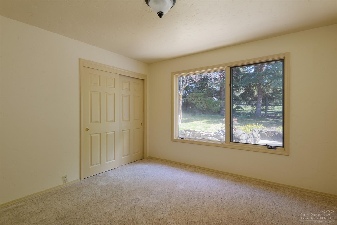 63050 Dickey Road Bend, OR 97701 - Photo 21 of 25 a view of an empty room with a window