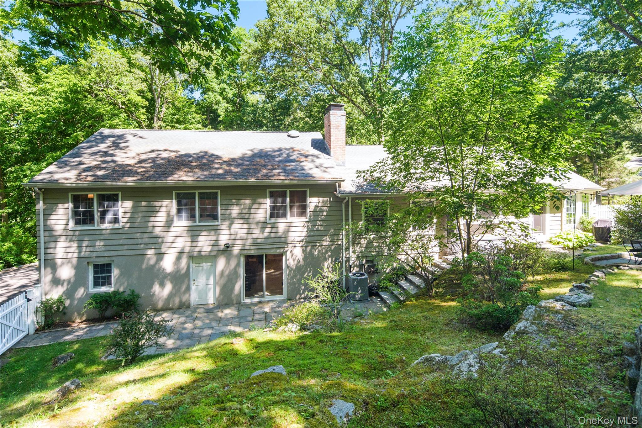 105 Cross Ridge Road Chappaqua, NY 10514 - Photo 6 of 43 The lower level recreation room features sliding glass doors open to the patio, rock outcroppings provide texture and visual interest