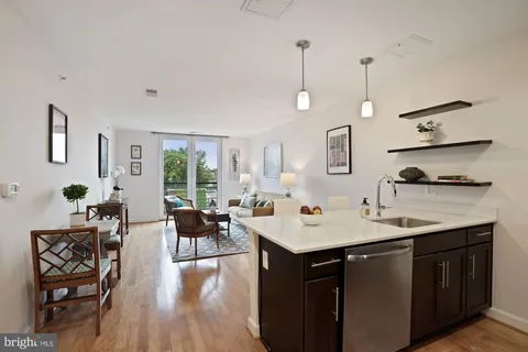 a open kitchen with a sink stove and wooden floor