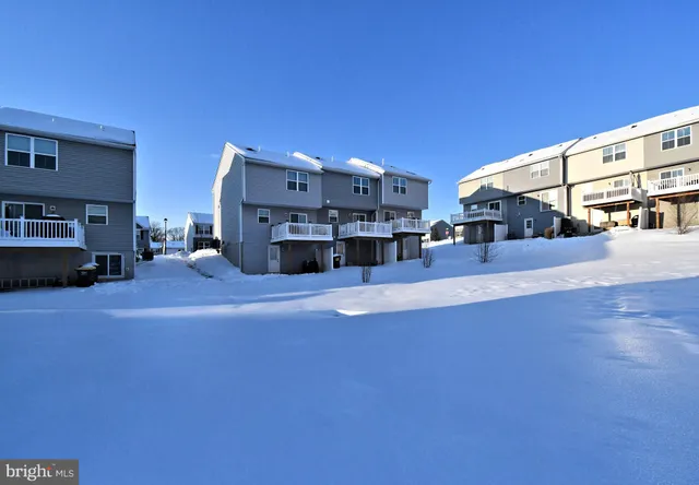 a view of a balcony with wooden chairs