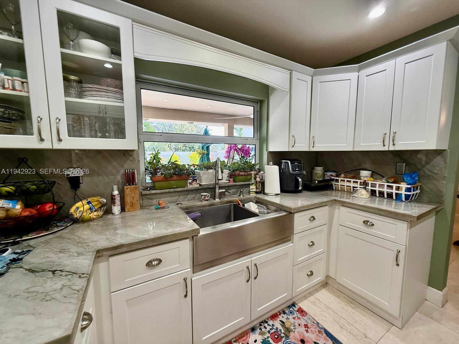 2725 Southwest 102nd Avenue Miami, FL 33165 - Photo 16 of 34 a kitchen with stainless steel appliances granite countertop a sink window and cabinets