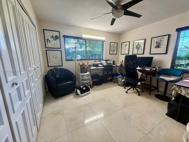 a view of a livingroom with workspace and a window