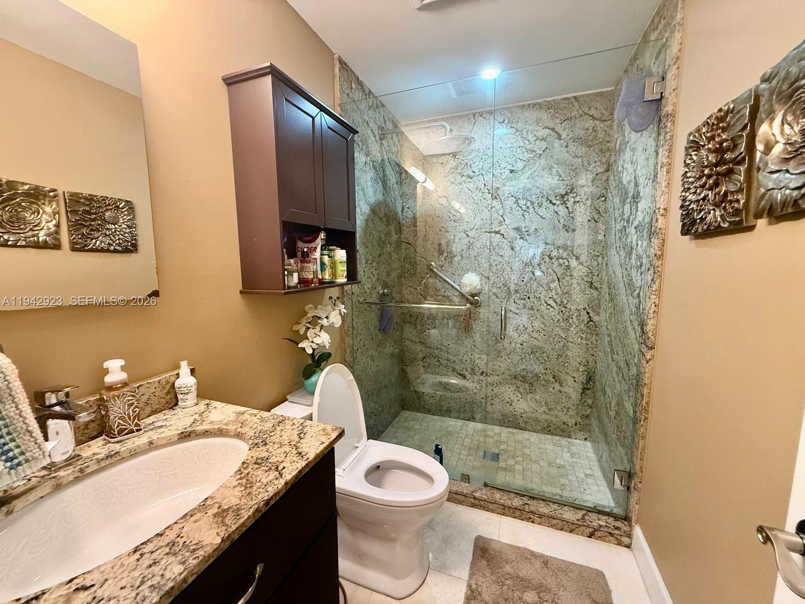 2725 Southwest 102nd Avenue Miami, FL 33165 - Photo 21 of 34 a bathroom with a granite countertop sink toilet and shower