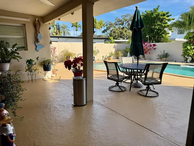 a view of a porch with furniture and garden