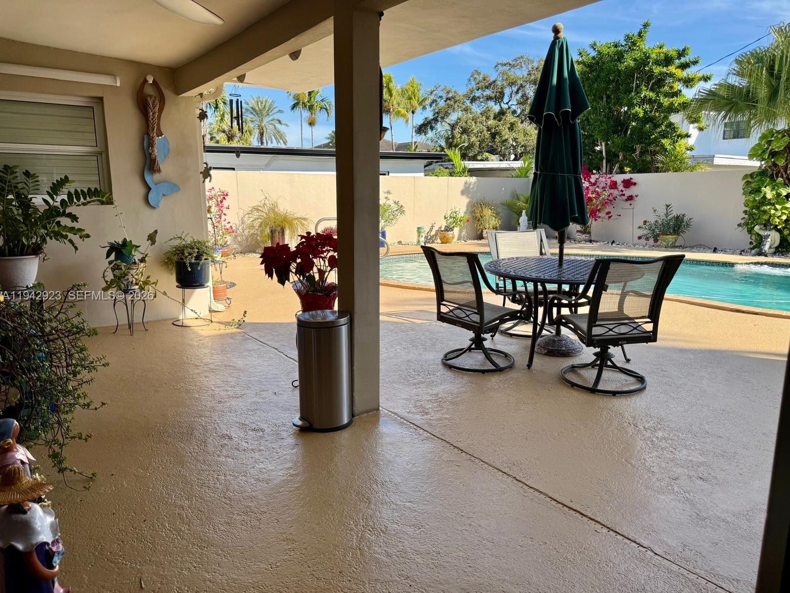 2725 Southwest 102nd Avenue Miami, FL 33165 - Photo 23 of 34 a view of a porch with furniture and garden
