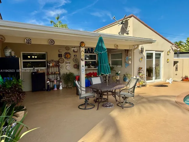 a view of a patio with dining table and chairs