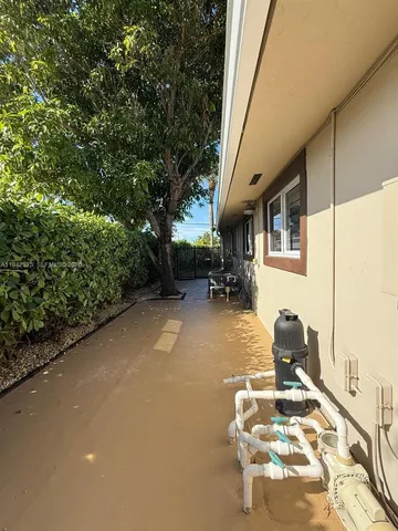 a backyard of a house with table and chairs
