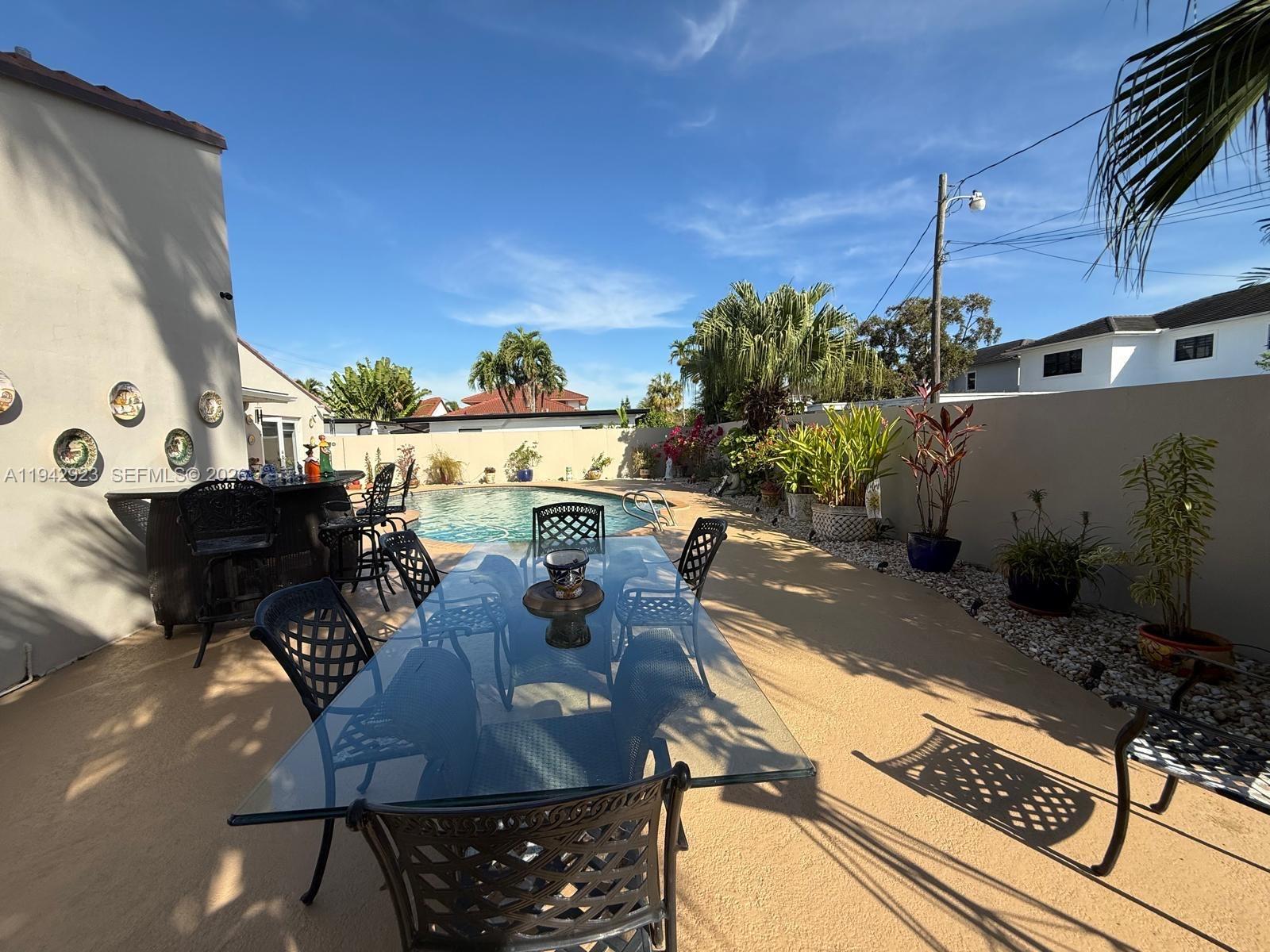 2725 Southwest 102nd Avenue Miami, FL 33165 - Photo 26 of 34 a view of a patio with table and chairs with plants