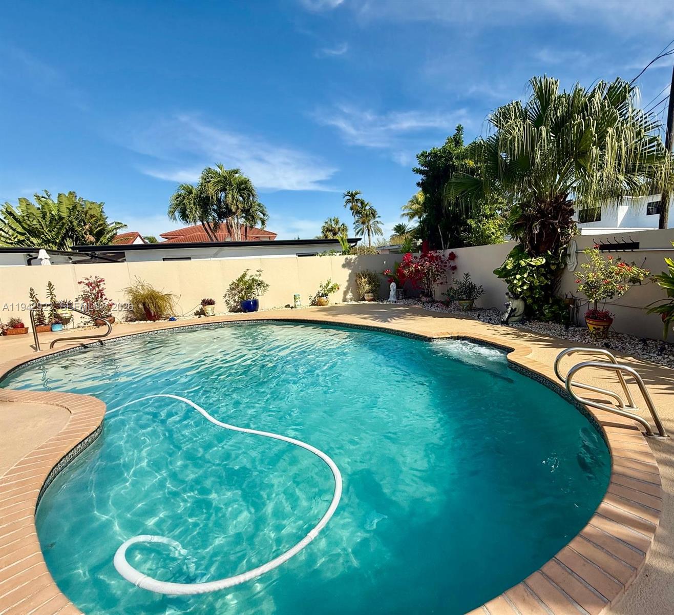 2725 Southwest 102nd Avenue Miami, FL 33165 - Photo 30 of 34 a view of a swimming pool with a yard