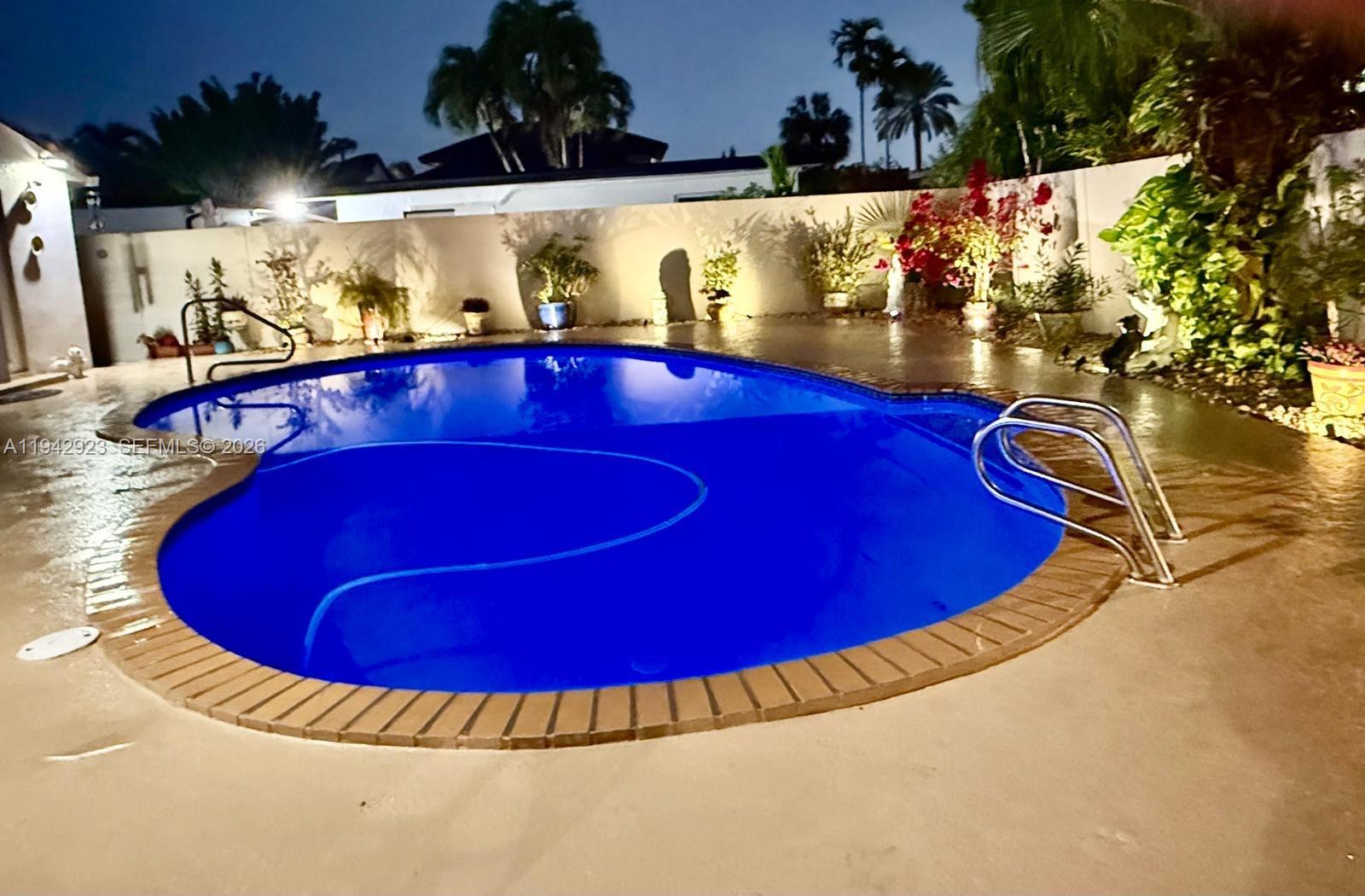 2725 Southwest 102nd Avenue Miami, FL 33165 - Photo 31 of 34 a view of a swimming pool with an outdoor seating
